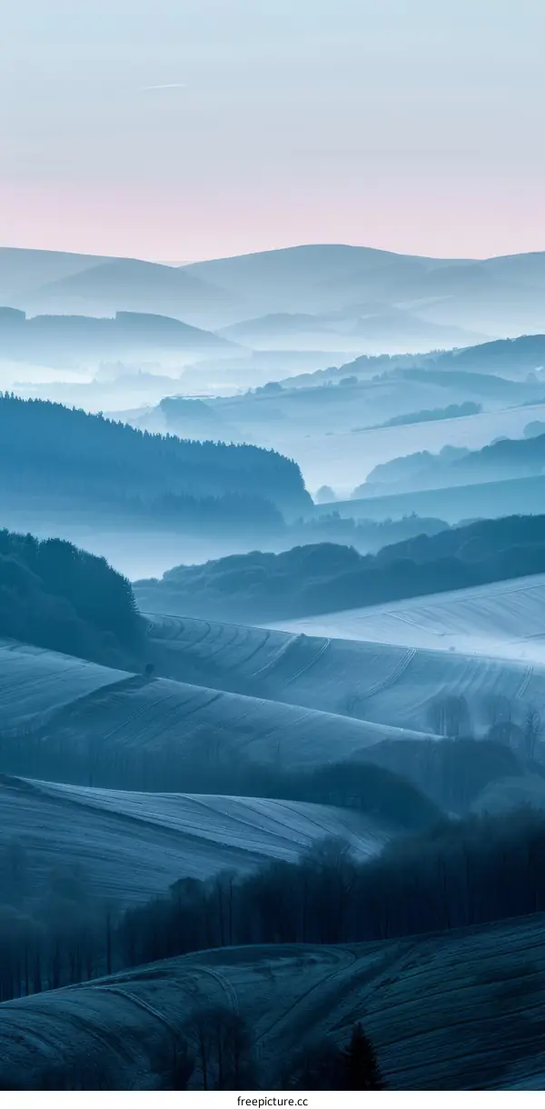 Blue hills and valleys in the morning mist