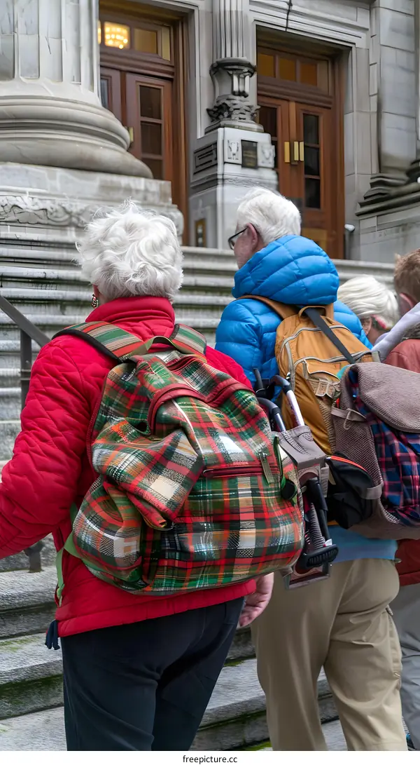 Backpackers on Steps in Front of Building