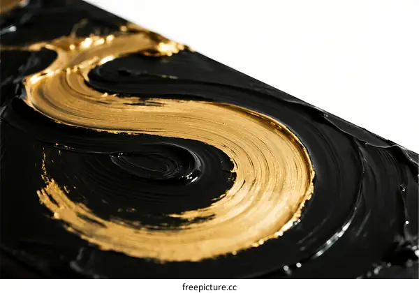 Golden Swirl Design on Black Surface with Smooth Texture