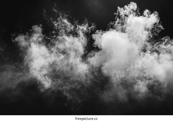 White smoke swirls against a black background