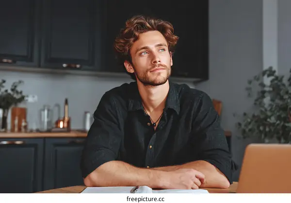 Thoughtful Caucasian Man in Kitchen