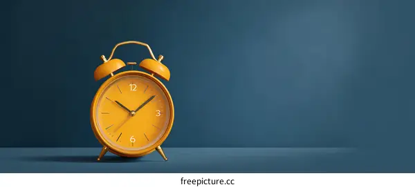 Orange Retro Alarm Clock on Dark Blue Background