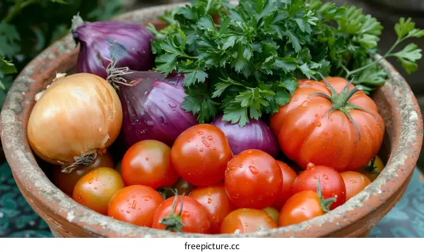 A clay bowl filled with shallots, tomatoes and parsley