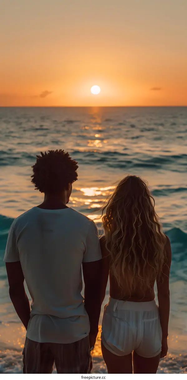 Couple Watching Sunset on Beach