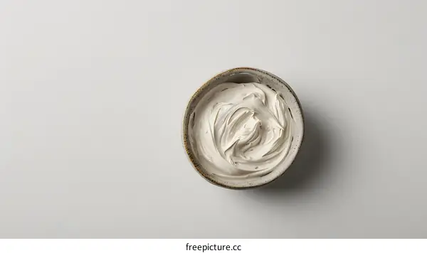 Bowl of white cosmetic clay on white background