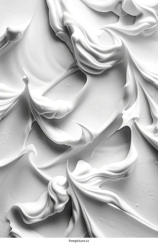 Close-up of white creamy substance with soft swirls and folds