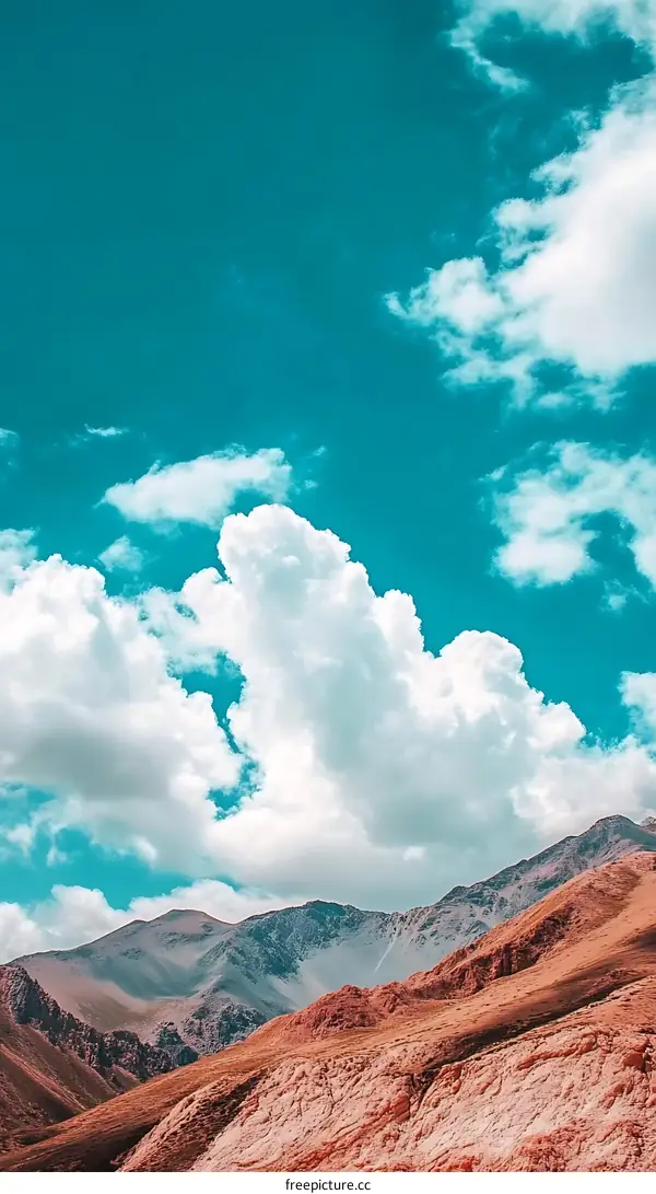 Beautiful Sky with Fluffy Clouds over Mountain Range