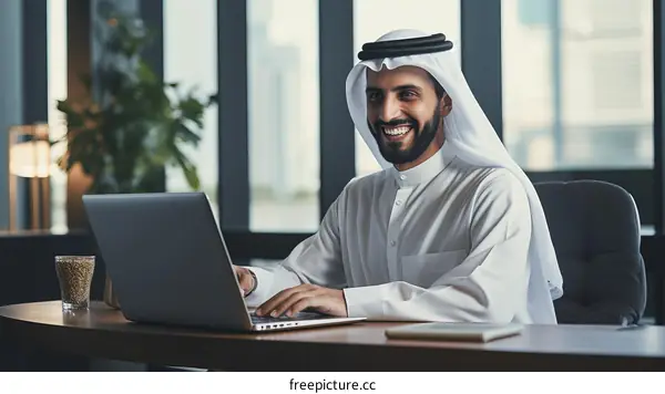 Arab businessman working on laptop computer in modern office