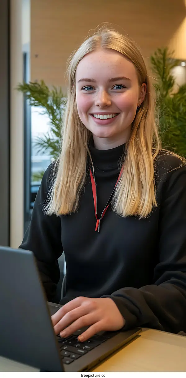 Young Woman Working on Laptop in Office