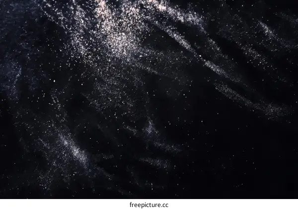 Abstract Texture of Scattered Particles on Dark Background