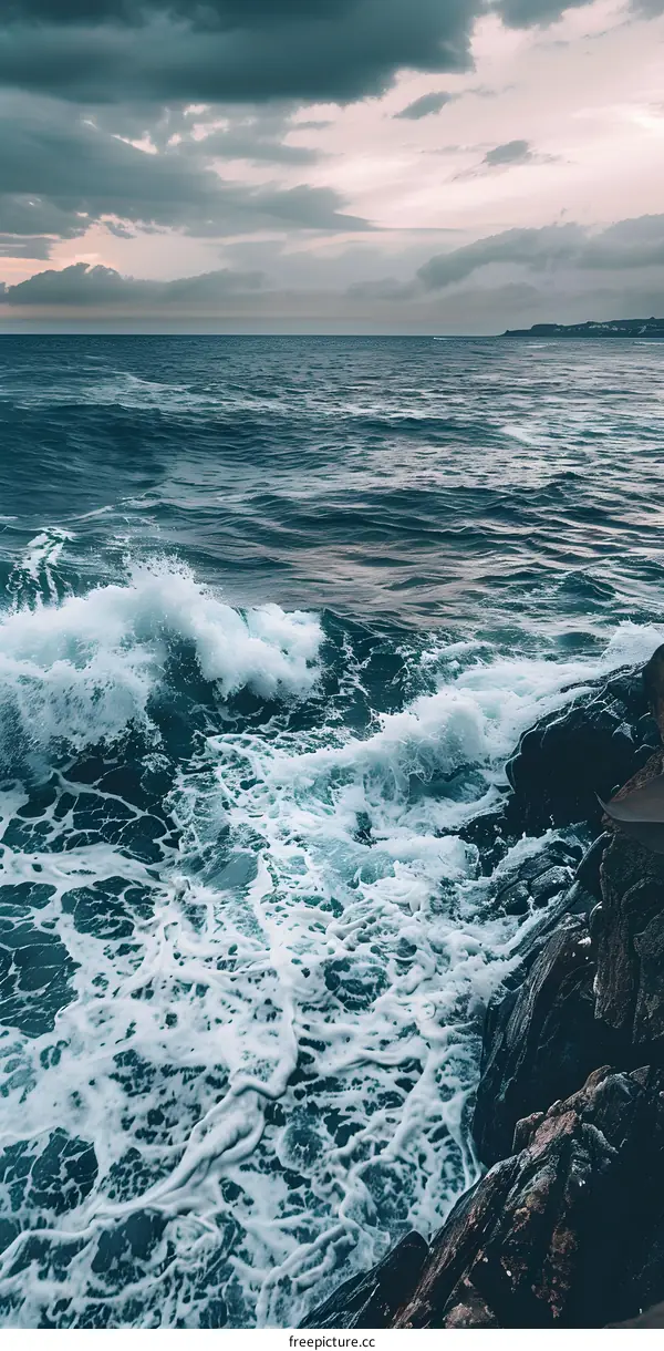Ocean Waves Crashing on Rocky Shore Under Stormy Sky