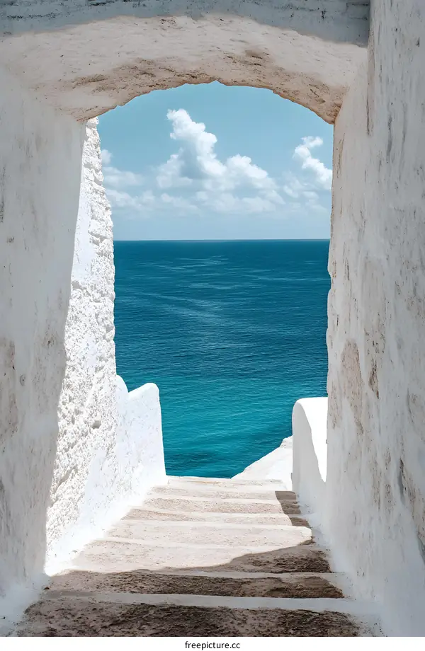 Stone Steps Leading to the Sea Through a White Archway