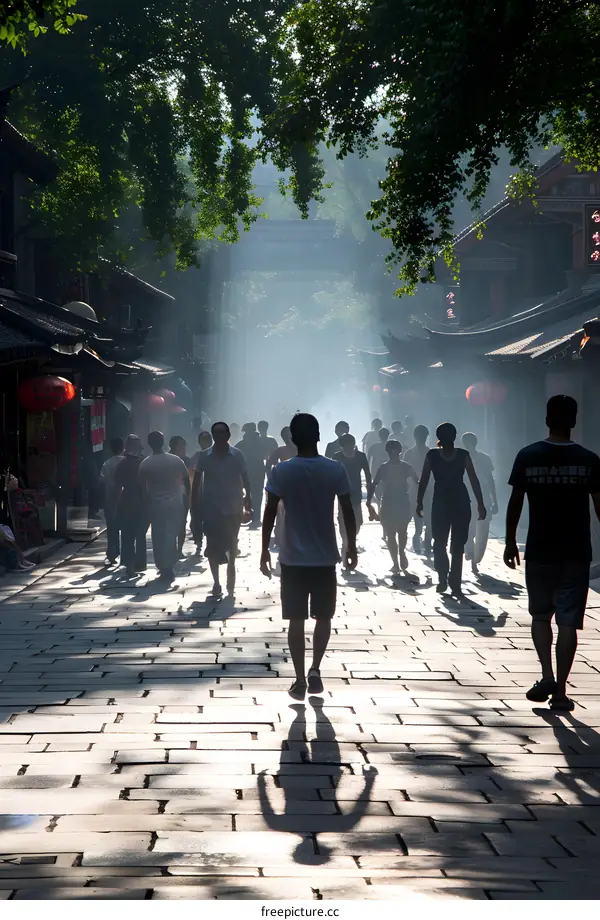 Silhouettes of People Walking Through an Alleyway in a Chinese City