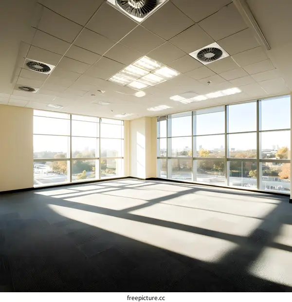 Empty Modern Office Space with Large Windows and Sunlight