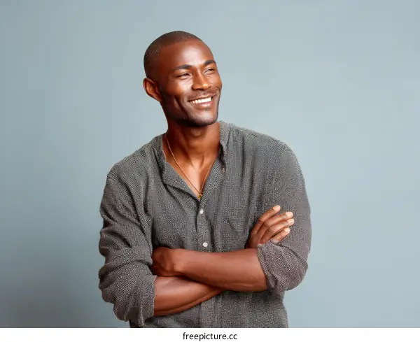 Smiling Black Man Posing Against a Light Gray Background