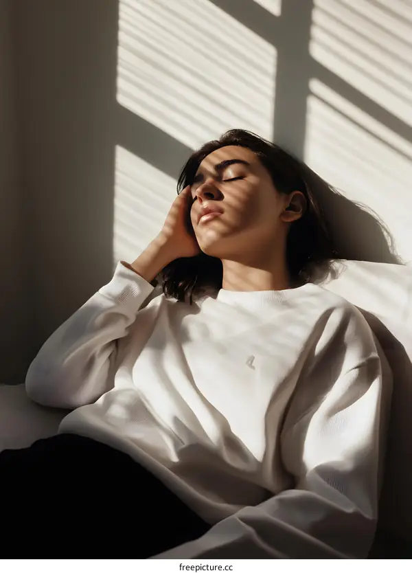 Woman Relaxing in a Chair with Sunshine Streaming in