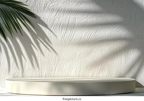 Elegant White Display Podium with Palm Leaf Shadow