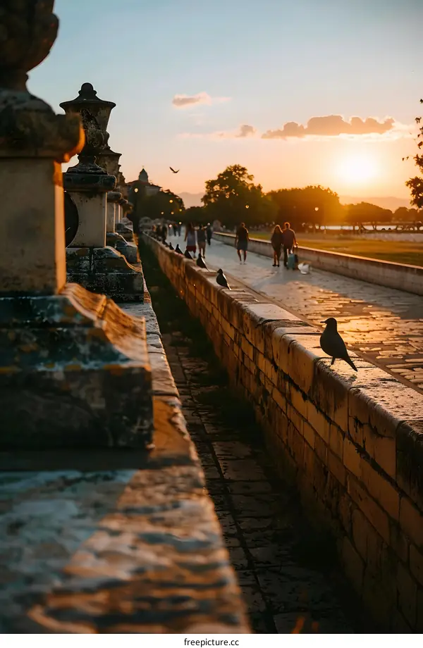 Stone Wall Path with Birds and People at Sunset
