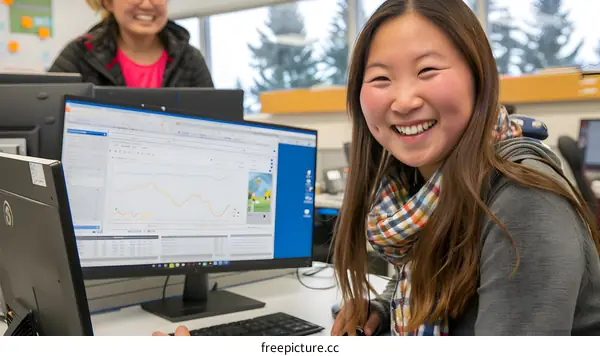 Smiling Woman Working at a Computer in an Office