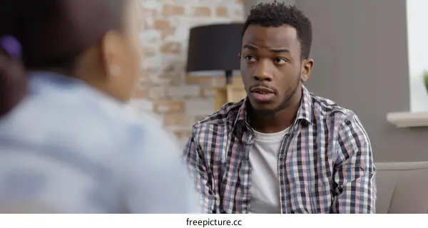 Young African American man talking to someone off camera