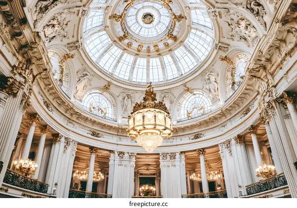 Golden Chandelier And Glass Dome Ceiling in Grand Architectural Building