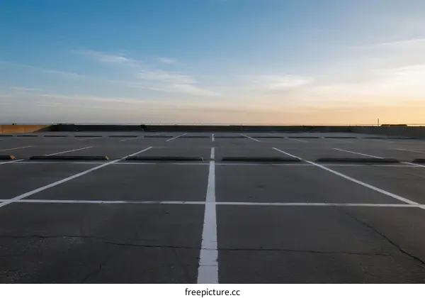 Empty parking lot under clear sky during sunset time
