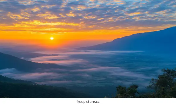 Sunrise Over Misty Mountain Valley Landscape