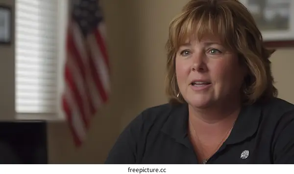 Woman Speaking with American Flag in Background