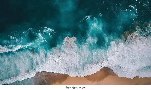 Aerial View of Ocean Waves Crashing on Sandy Beach