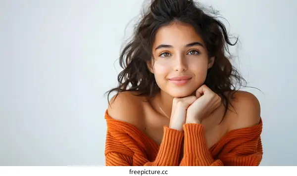 Beautiful Woman with Brown Hair and Eyes Wearing Orange Sweater