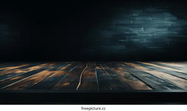 Empty wooden table with dark brick wall background