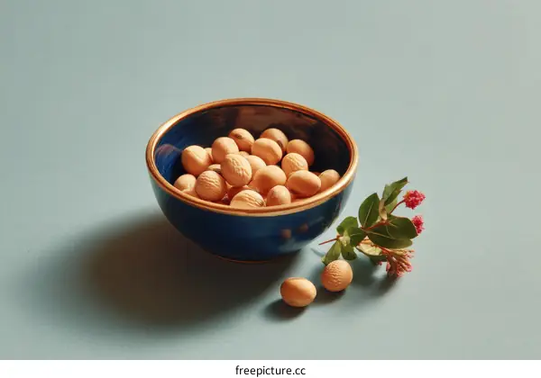 Small Light Tan Seeds in a Blue Bowl with Flowers