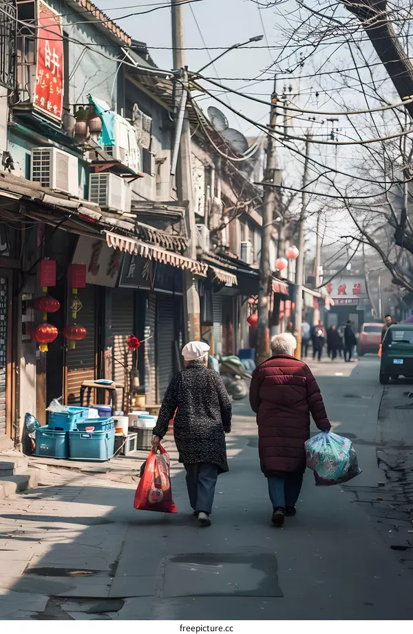 Two Elderly Women Walking Down a Narrow Street in China