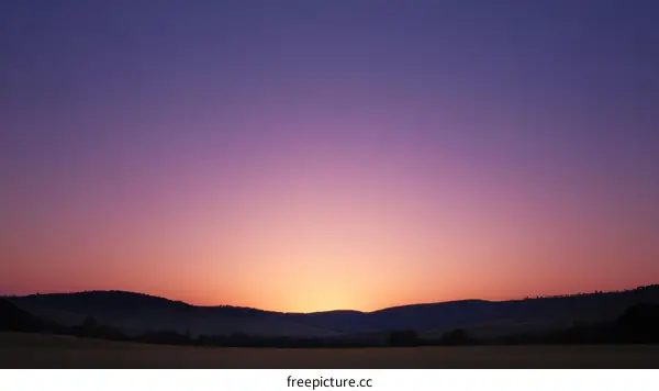 Sunrise over rolling hills