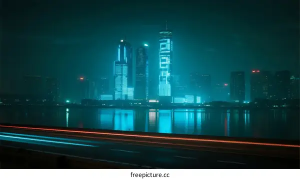 Night view of futuristic city with illuminated skyscrapers and light trails