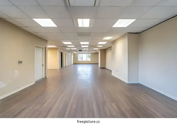 Empty Office Space with Beige Walls and Wood Floor