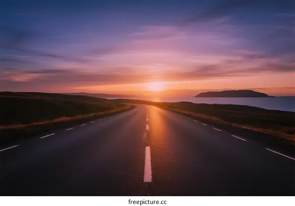 The beautiful road stretching under the colorful sunset sky