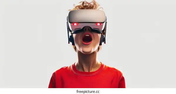 Amazed young boy wearing virtual reality headset