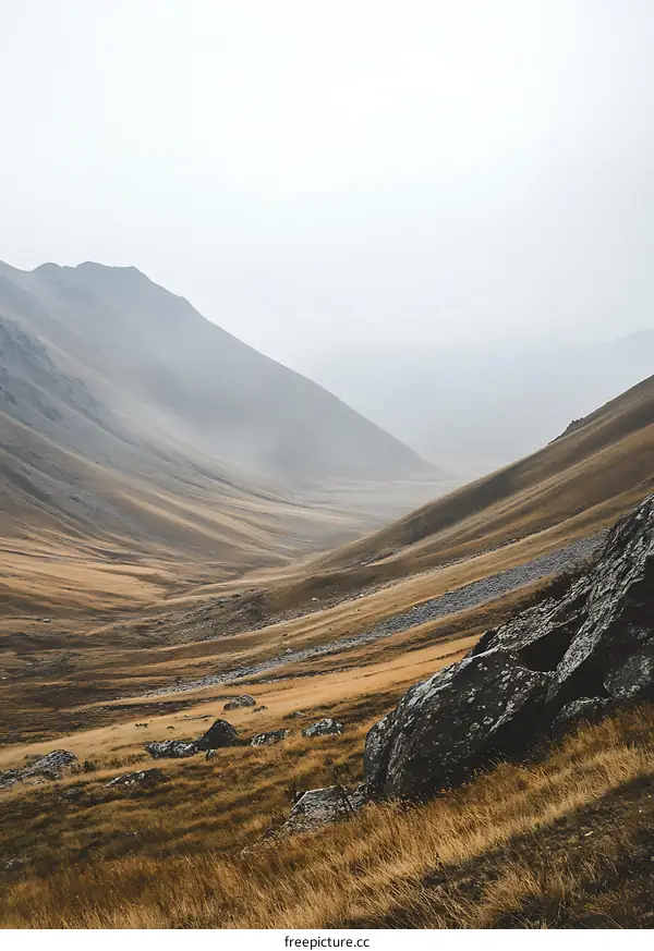 Mountain Valley Landscape With Foggy Sky