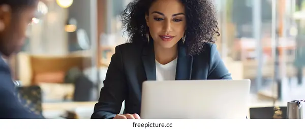 African American Woman Working on Laptop in Cafe