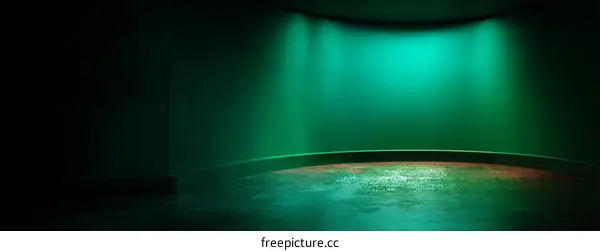Empty Studio Scene with Teal Walls and Spotlight