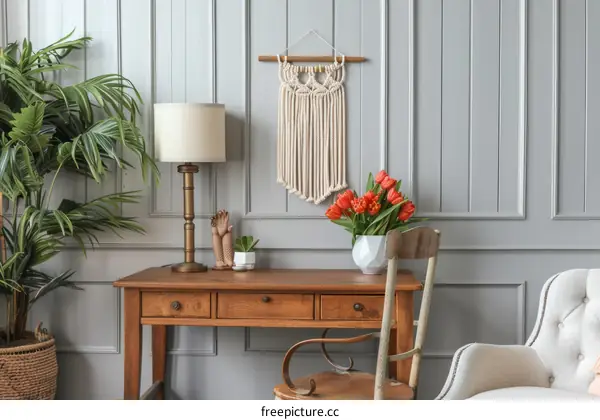 Home interior with macrame wall hanging, flowers in vase, wooden table and chair