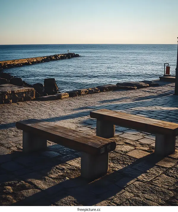 Two Wooden Benches By The Sea