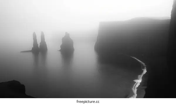 Black and white photo of the Reynisdrangar sea stacks off the coast of Iceland