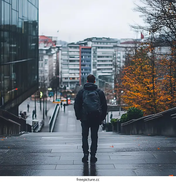Man with Backpack Walking Up Stairs in City