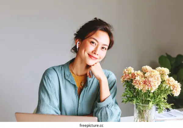 Asian Woman Relaxing at Home with Flowers