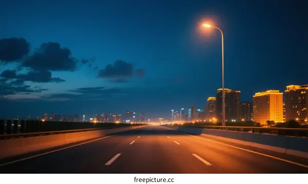 Night city road with bright street lamp and buildings