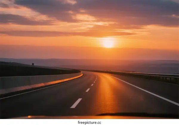 Sunset view of an empty highway under a colorful sky