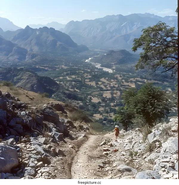A woman walking on a rocky path in the mountains