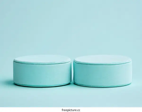 Two Pastel Blue Cylindrical Display Platforms